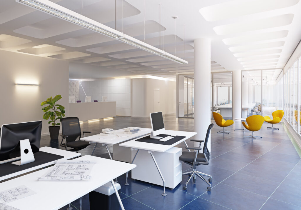 Contemporary white office with workstations, a reception desk and a seating area.