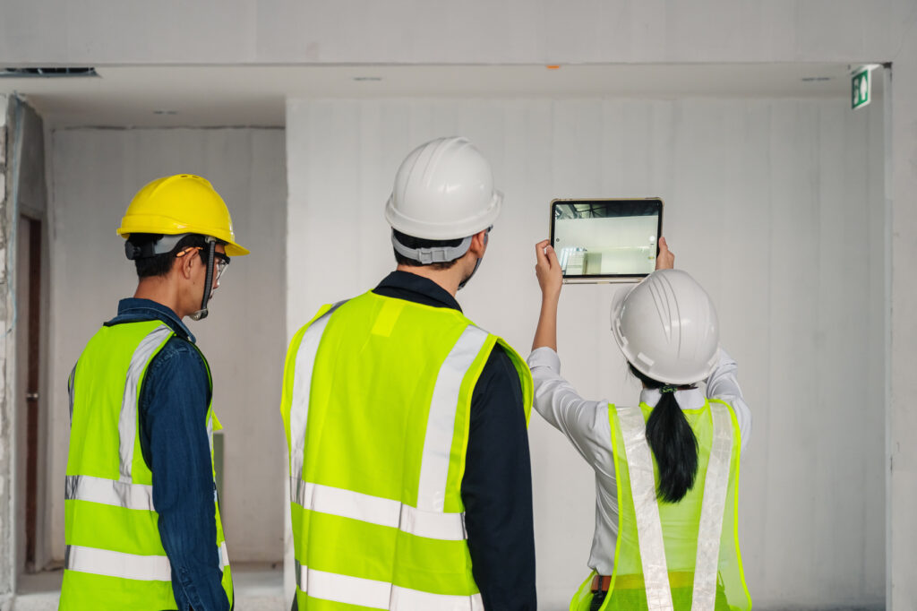 Inspection team recording an interior building condition with a tablet